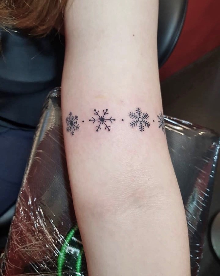 Elegant snowflake tattoo designs in fine lines
