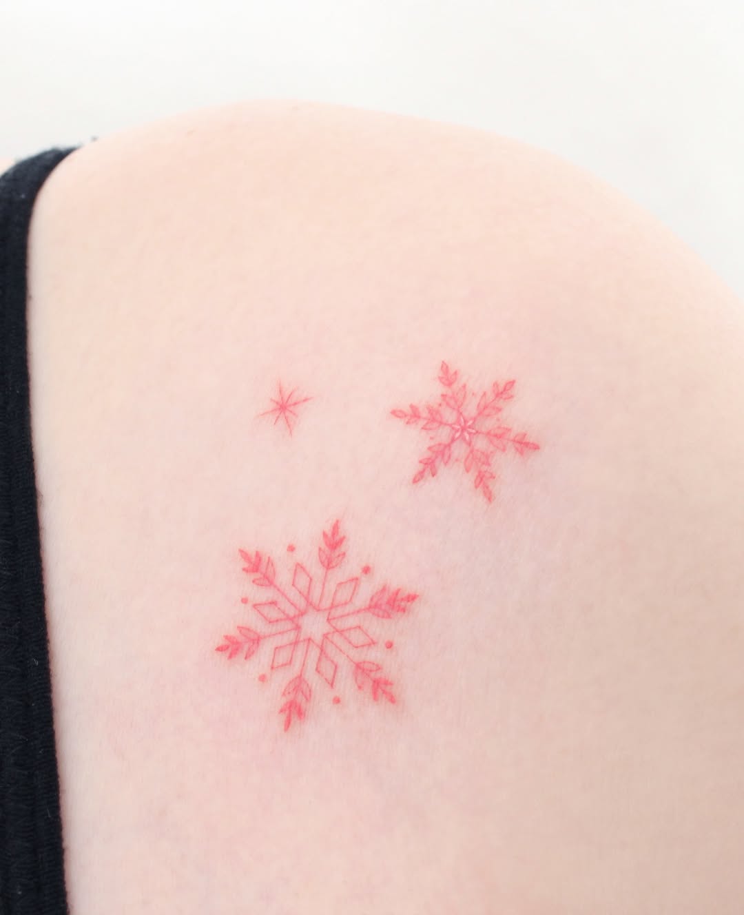 Vivid red snowflakes on subtle skin tone