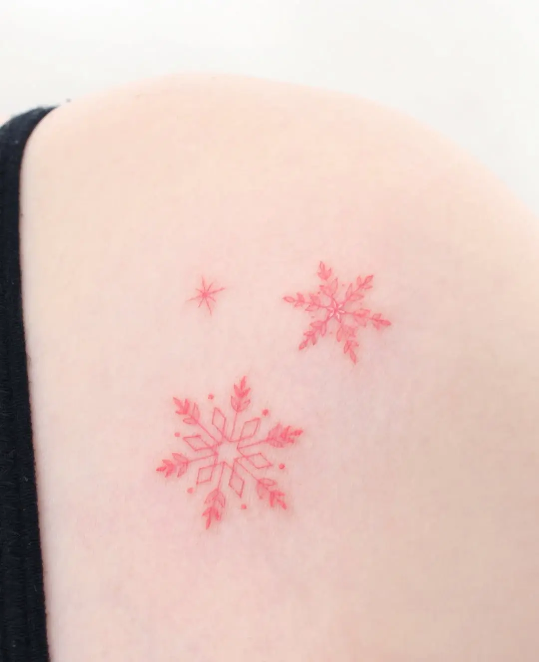 Vivid red snowflakes on subtle skin tone