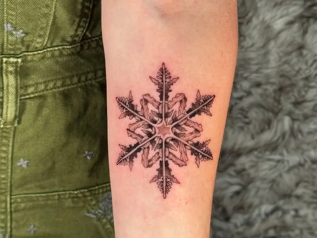 Intricate snowflake tattoo with delicate details