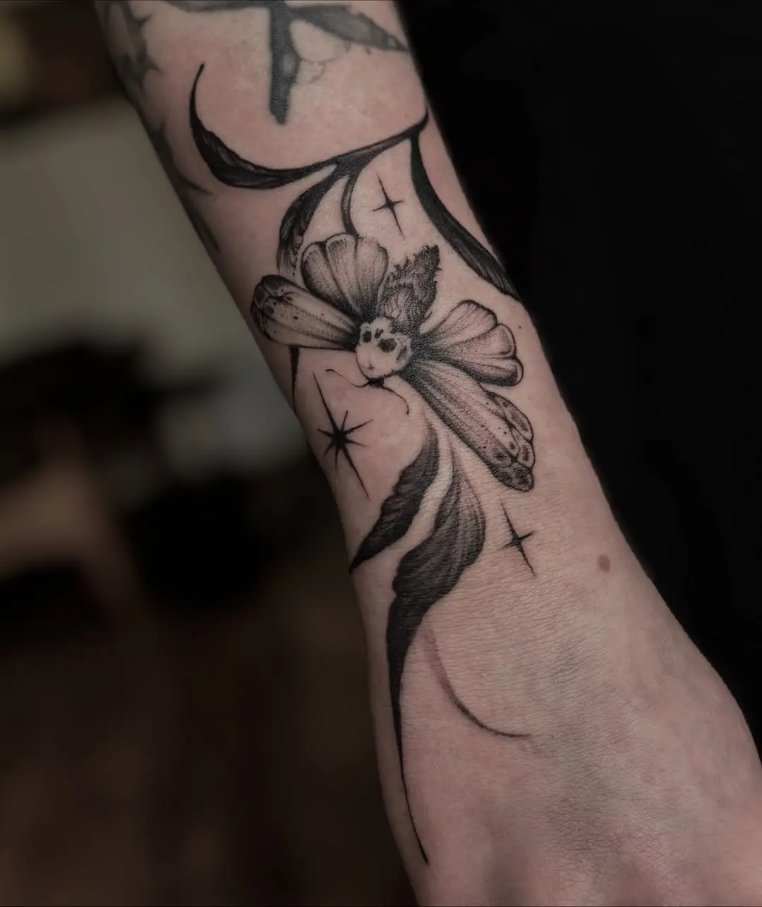 Intricate dotwork flower tattoo on the arm