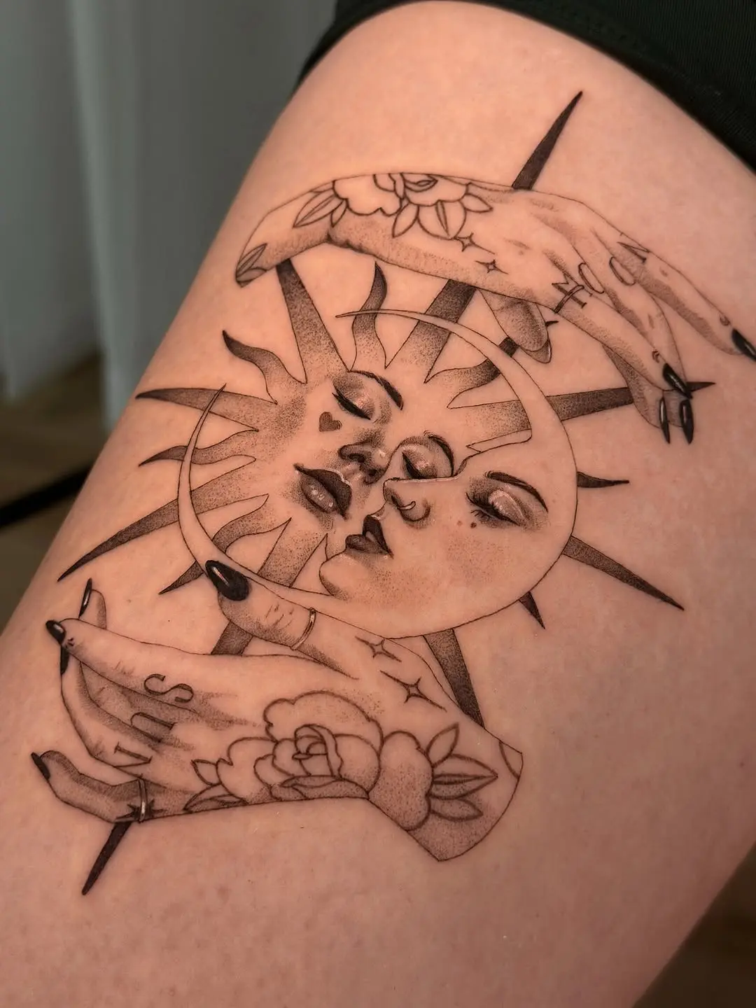 Intricate sun and moon dotwork tattoo design