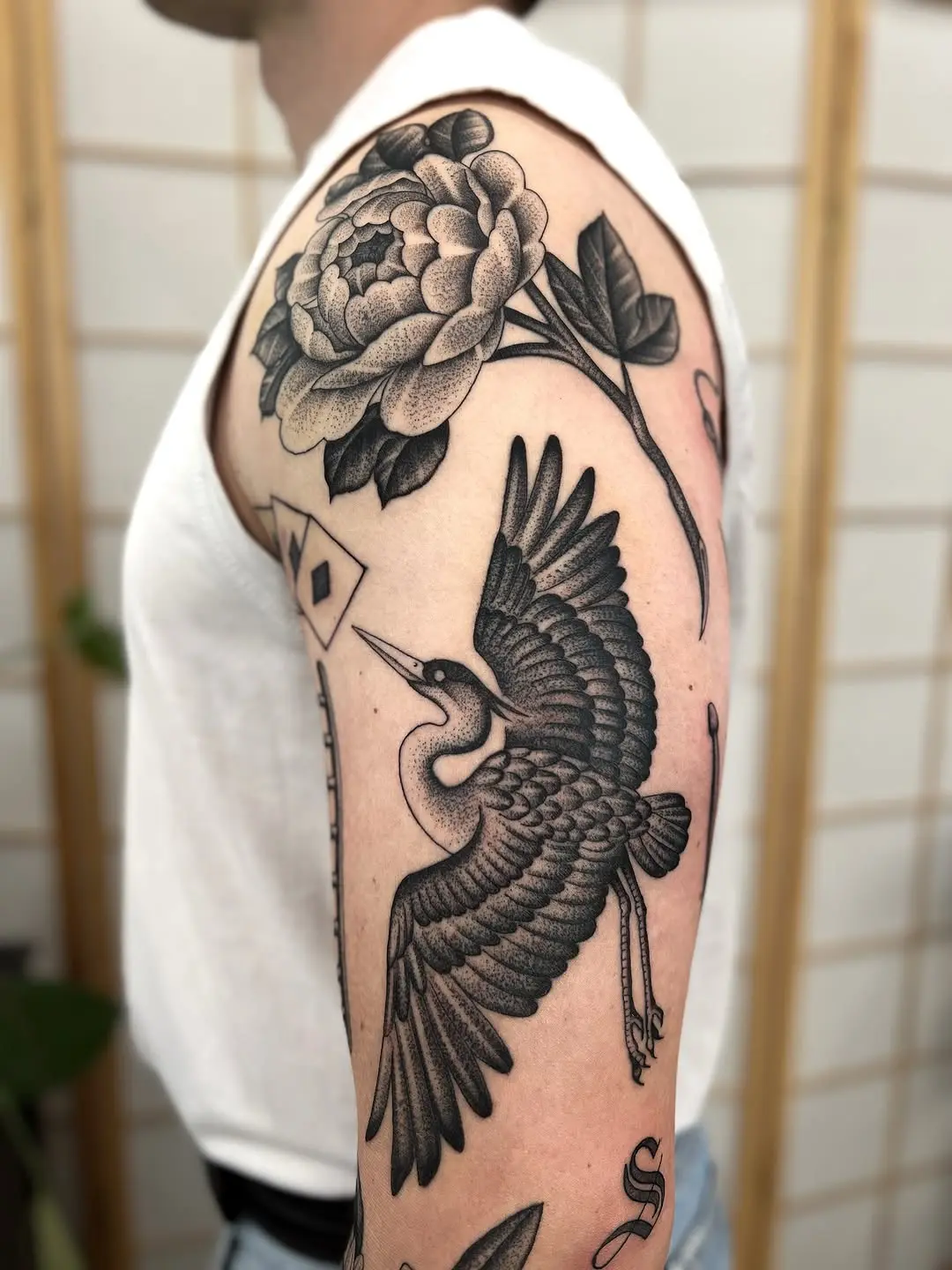 Elegant dotwork crane and peony tattoo design