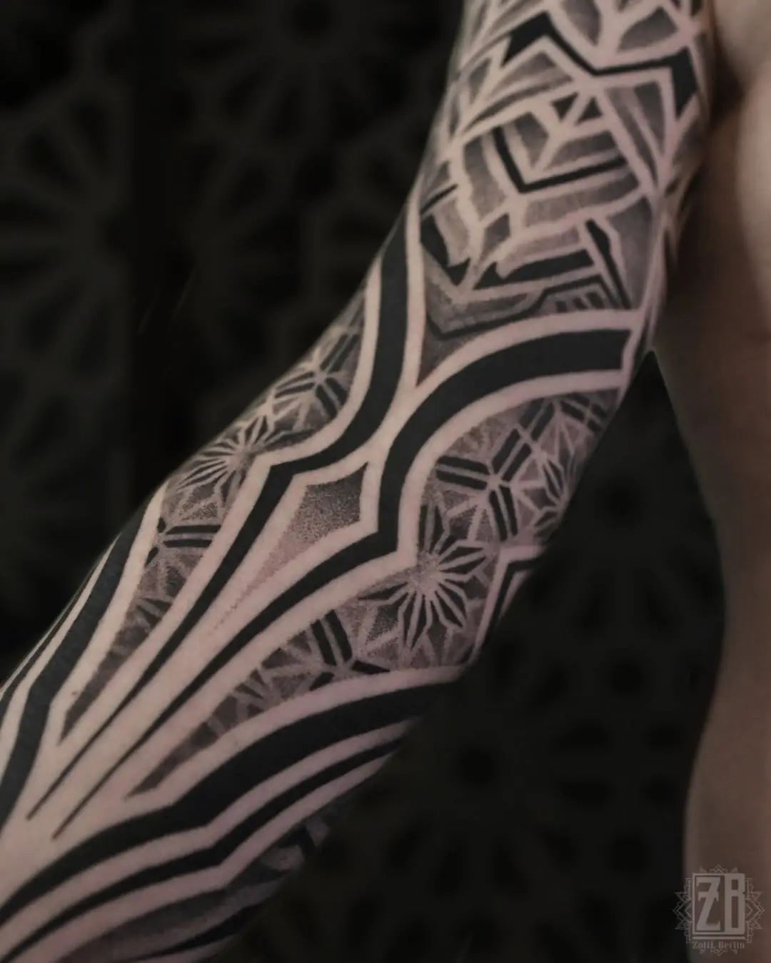 Intricate geometric dotwork tattoo on arm