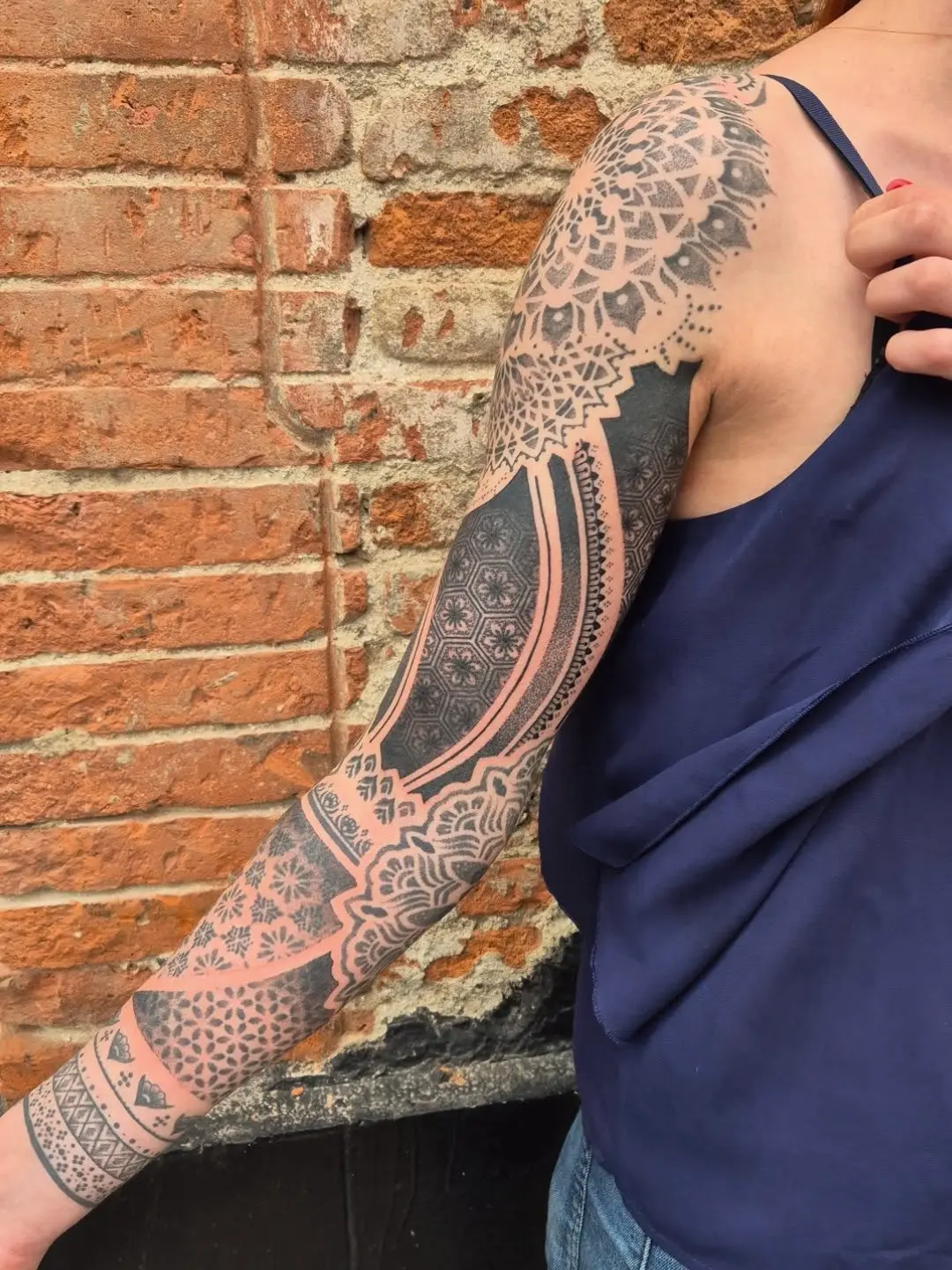 Intricate dotwork tattoo covering the arm