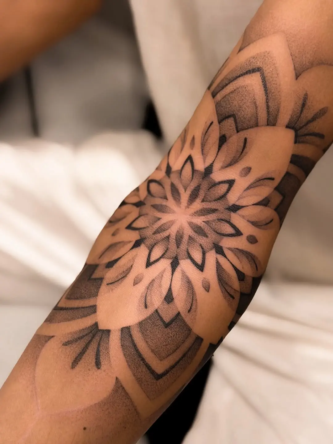 Intricate dotwork mandala tattoo design on forearm