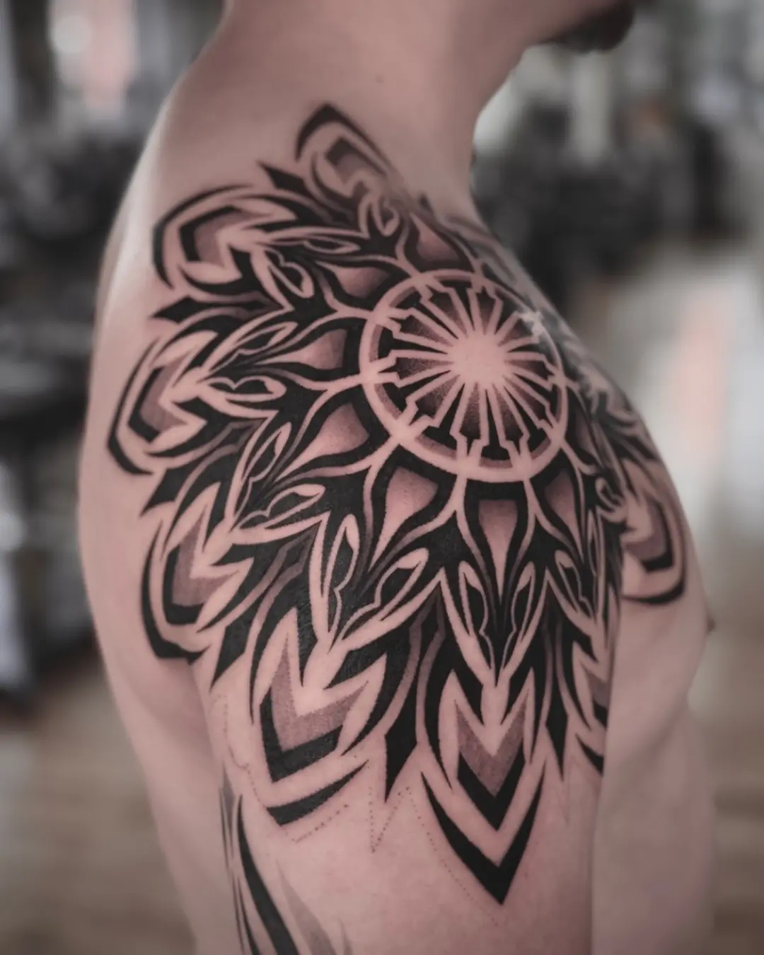 Intricate dotwork sunflower tattoo on shoulder