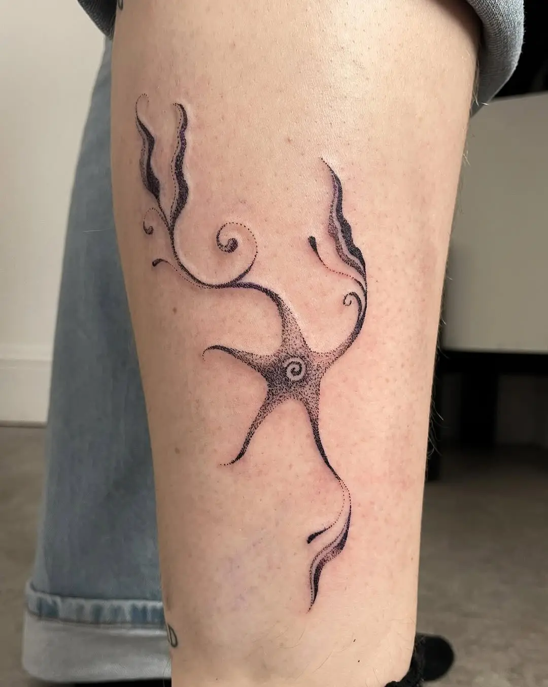 Abstract dotwork tattoo with swirling patterns