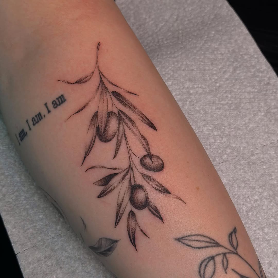 Graceful olive branch tattoo on forearm art