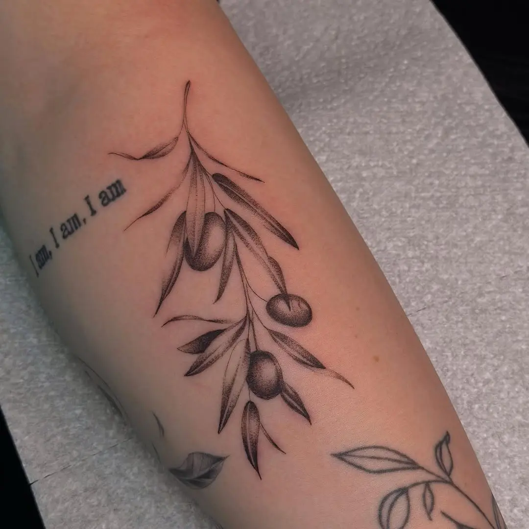 Graceful olive branch tattoo on forearm art