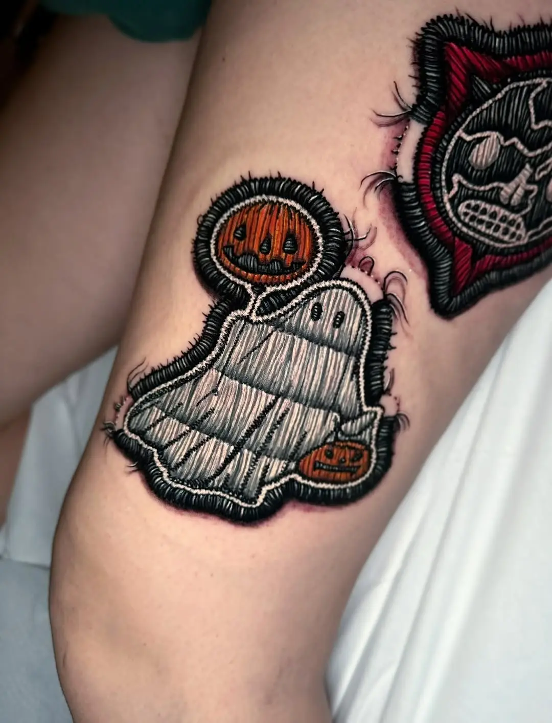 Charming ghost tattoo with Halloween pumpkins