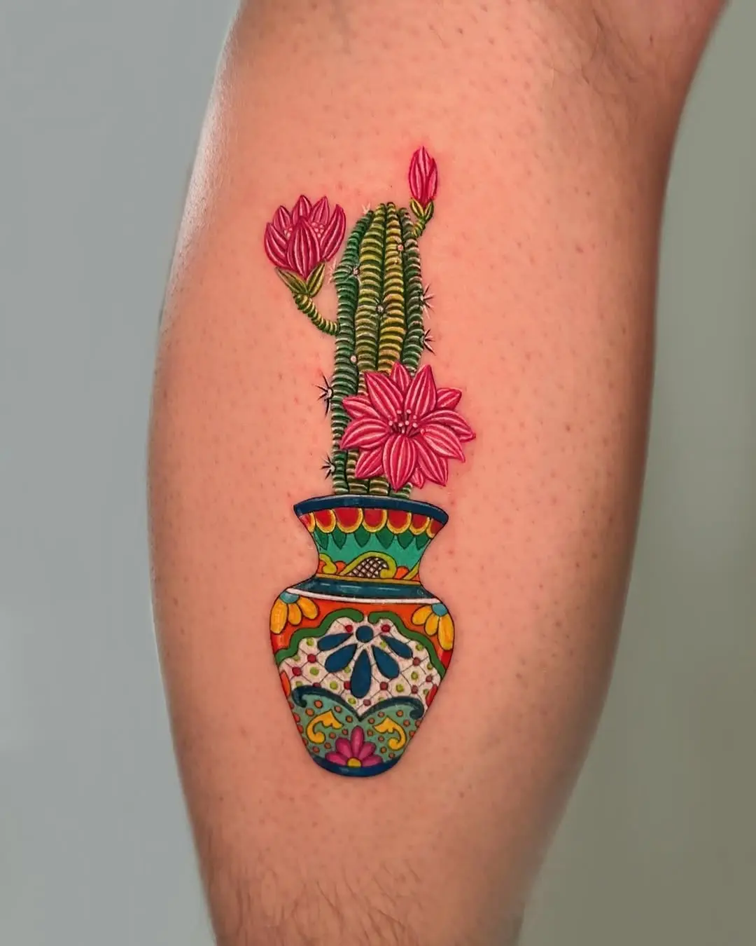 Vibrant cactus tattoo in decorative vase design