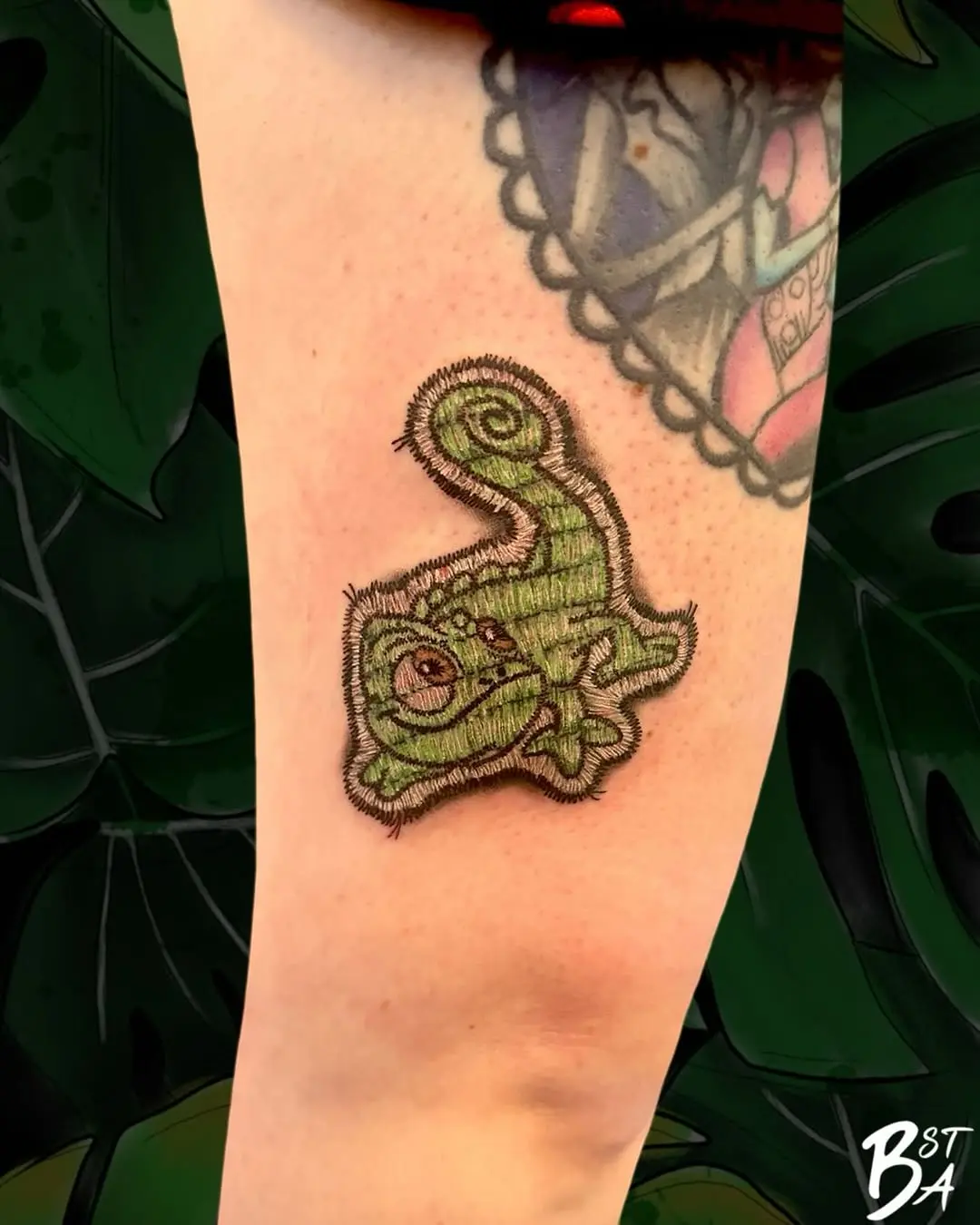 Vibrant chameleon tattoo exuding nature's charm