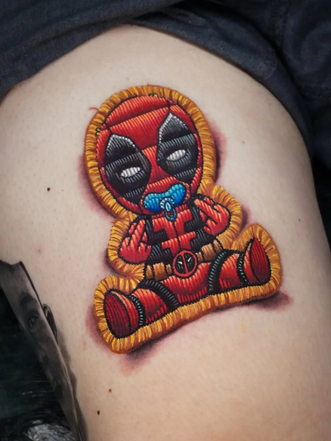 Whimsical Deadpool Embroidery-Inspired Tattoo