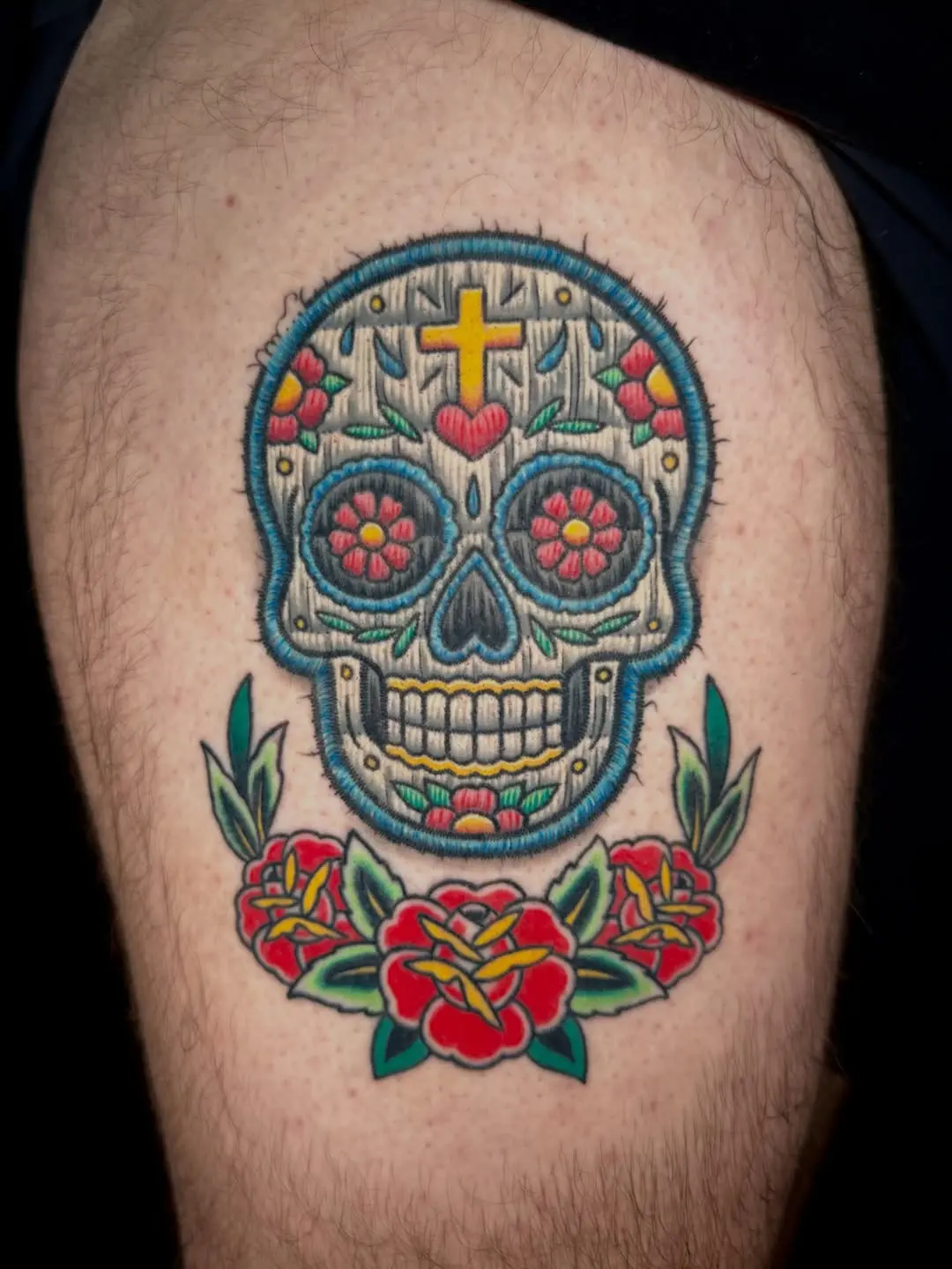 Colorful skull tattoo with floral details