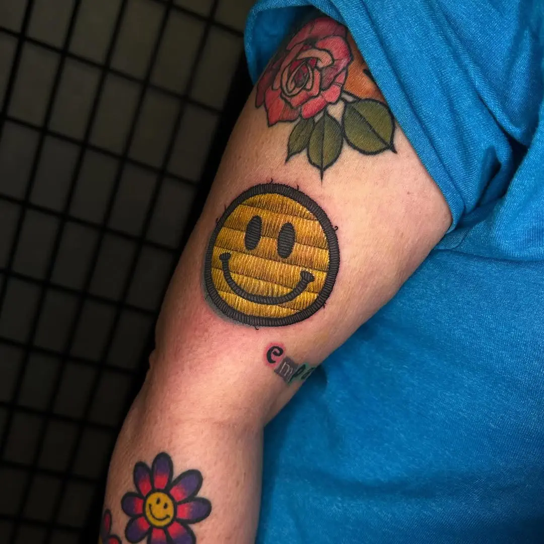 Unique embroidered smiley face tattoo design