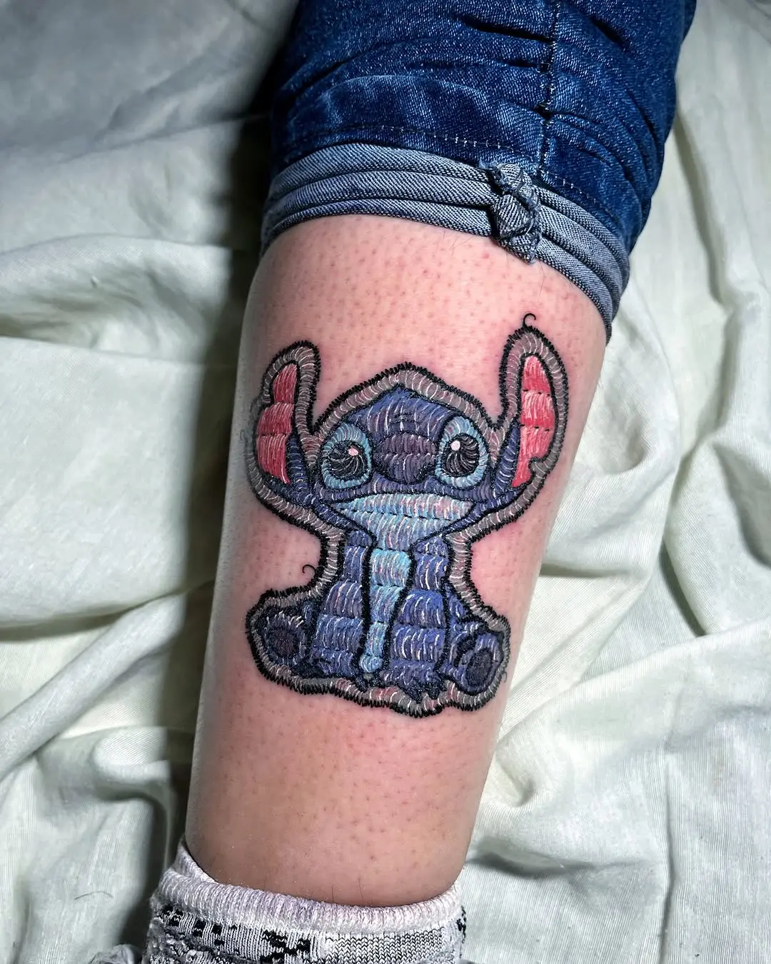 Unique Embroidery Tattoo of a Playful Character