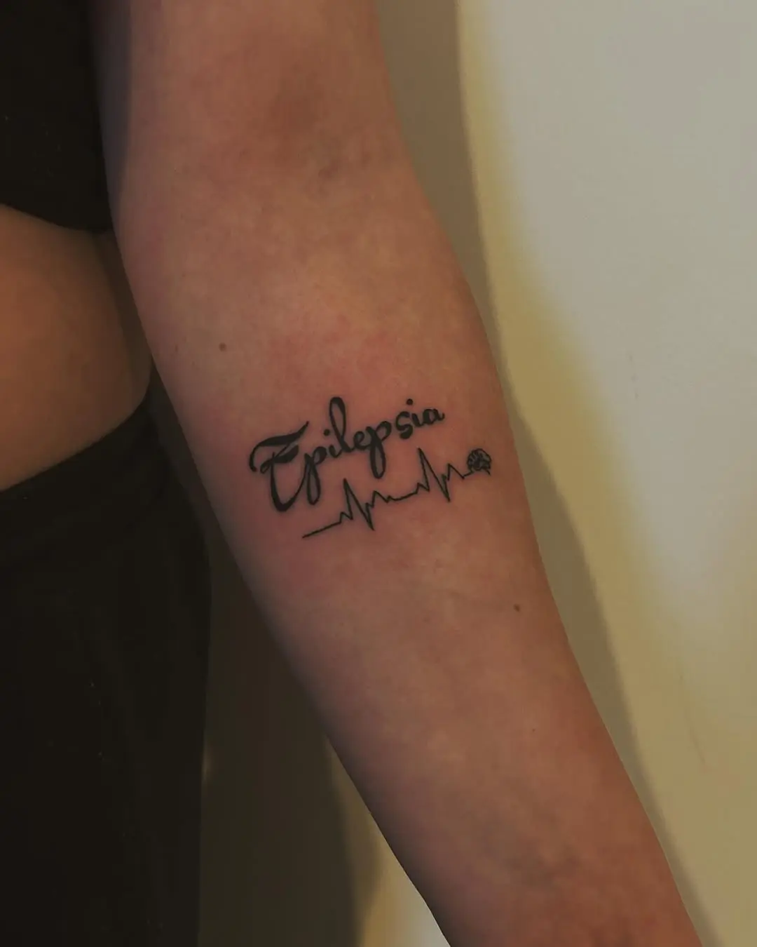 Unique epilepsy awareness tattoo with heartbeat line