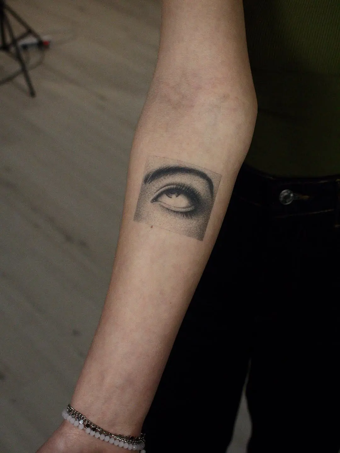 Intricate dotwork eye design on the arm