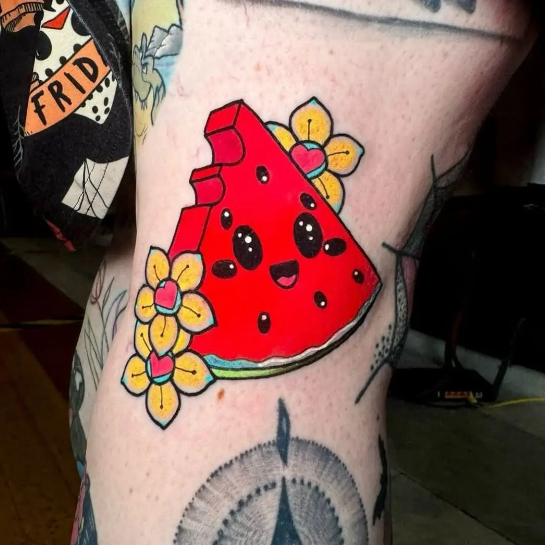 Playful watermelon tattoo with floral accents