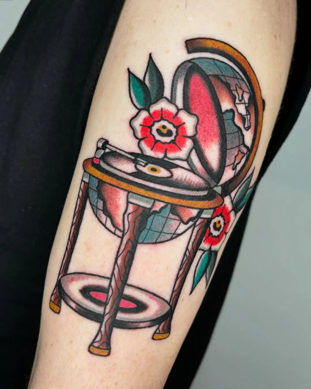 Unique globe tattoo with floral accents