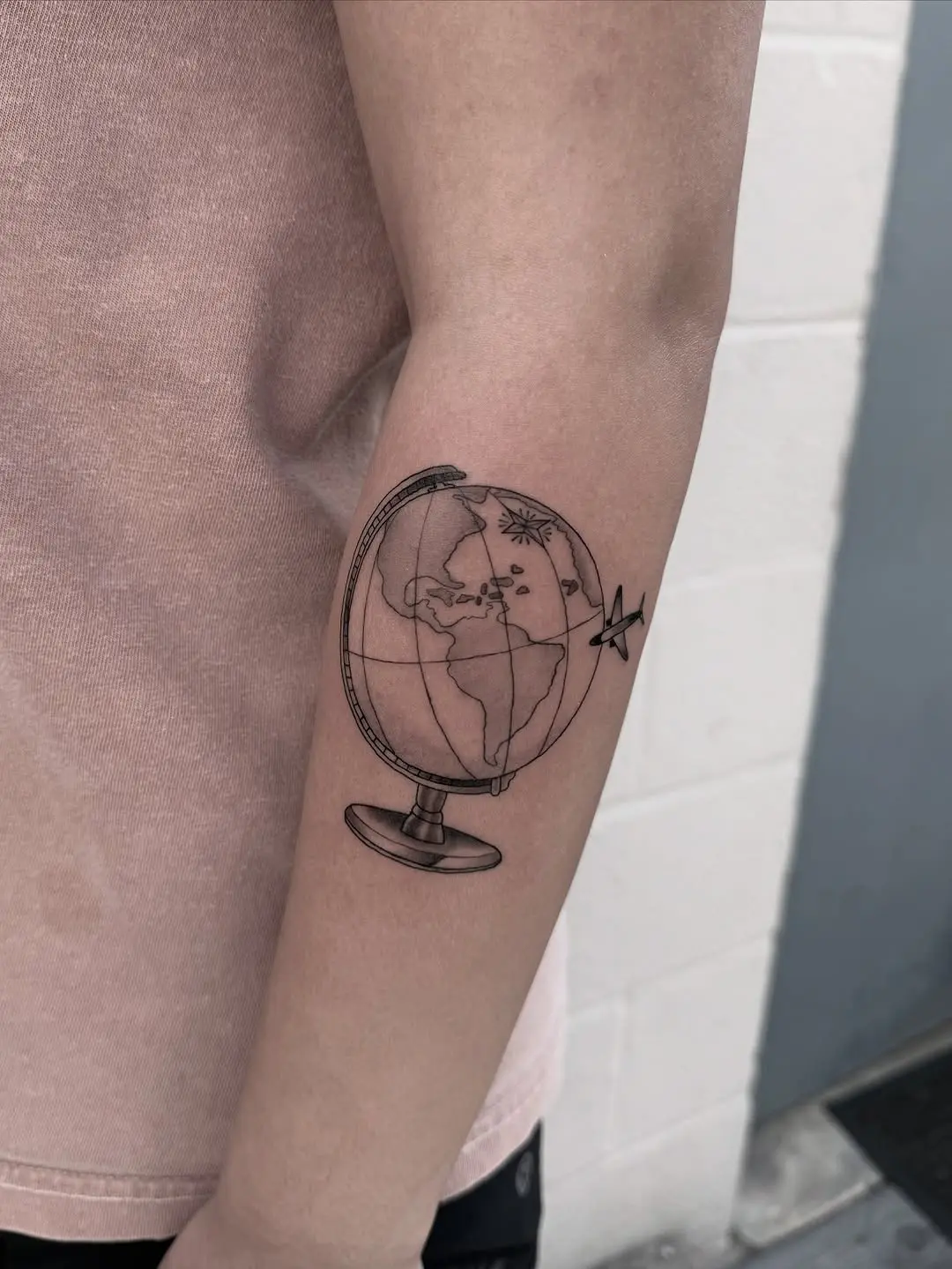 Unique globe tattoo showcasing artistic world map details
