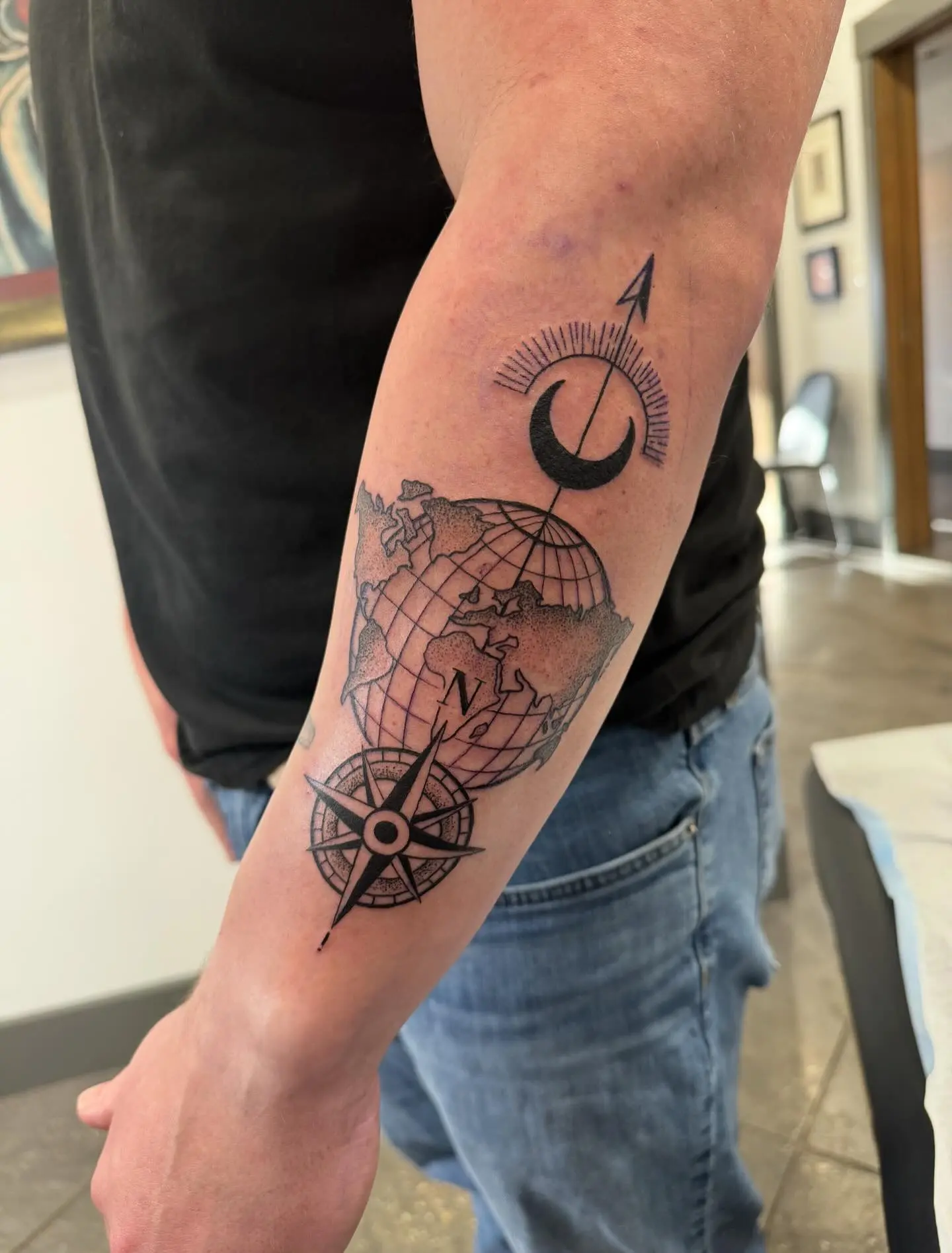 Intricate globe with compass tattoo design