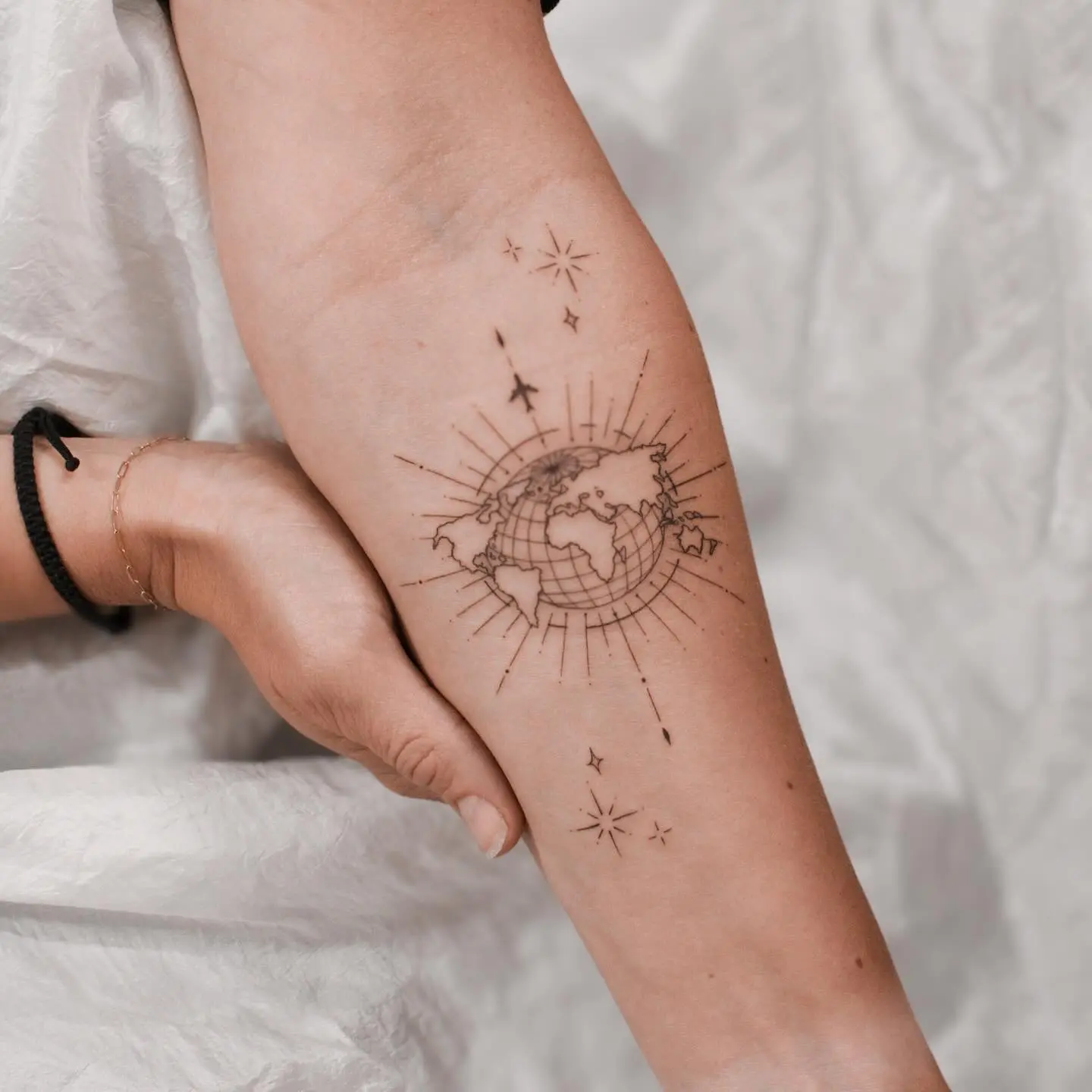 Intricate globe tattoo with star accents