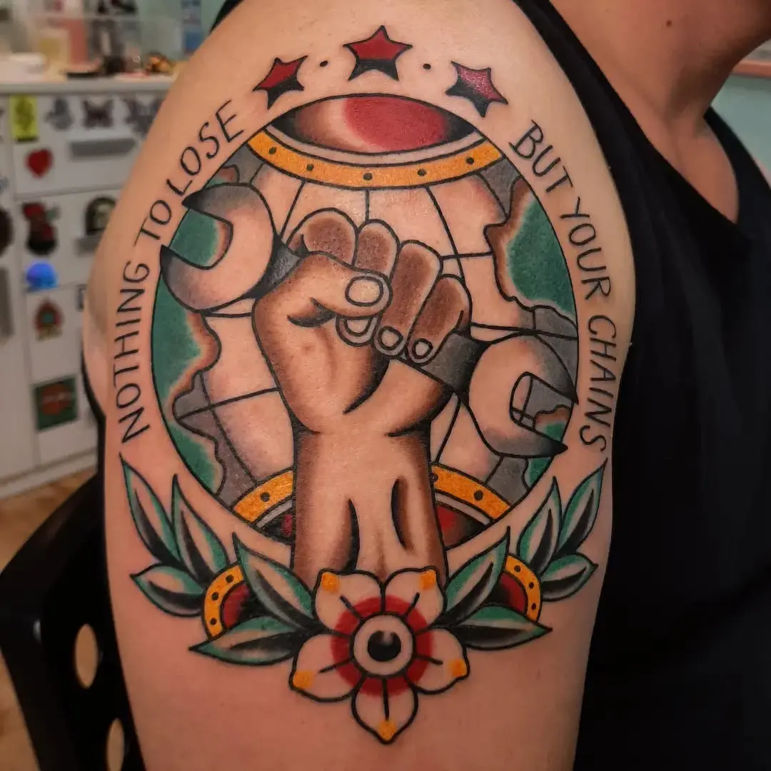 Empowering globe tattoo with a symbolic fist