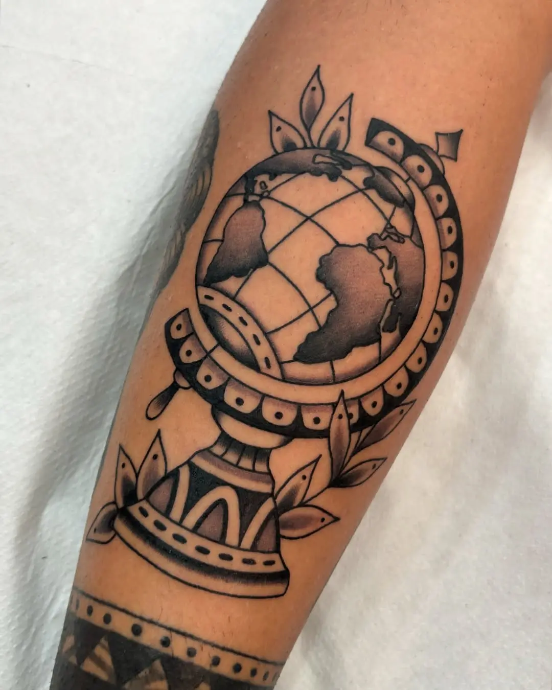 Artistic Globe Tattoo on Forearm