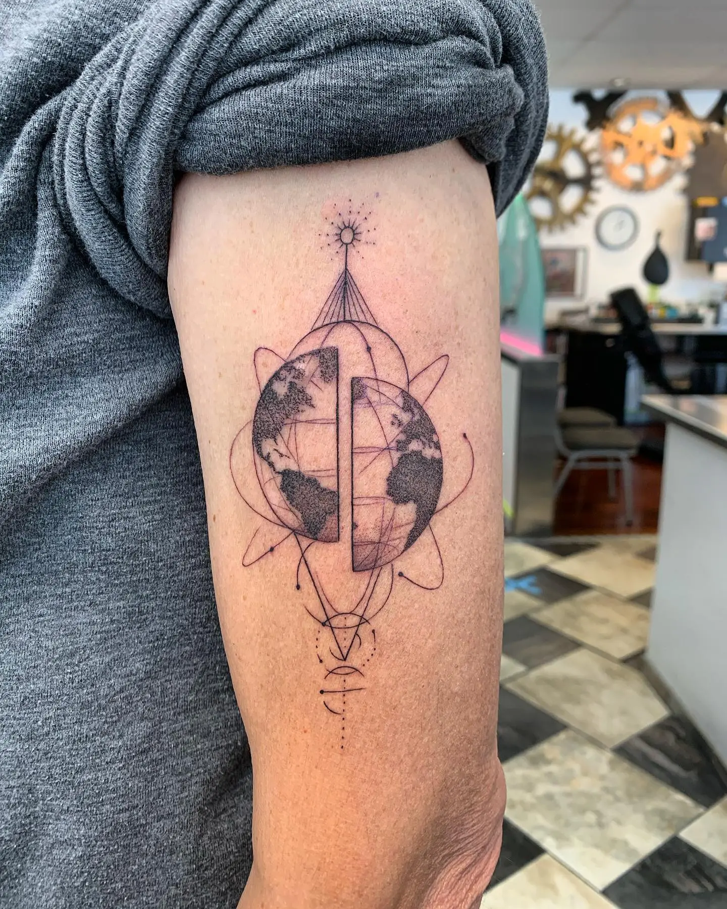 Stunning geometric globe tattoo design