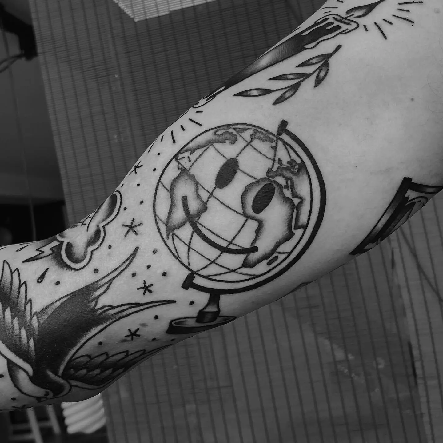 Whimsical globe tattoo with a cheerful vibe