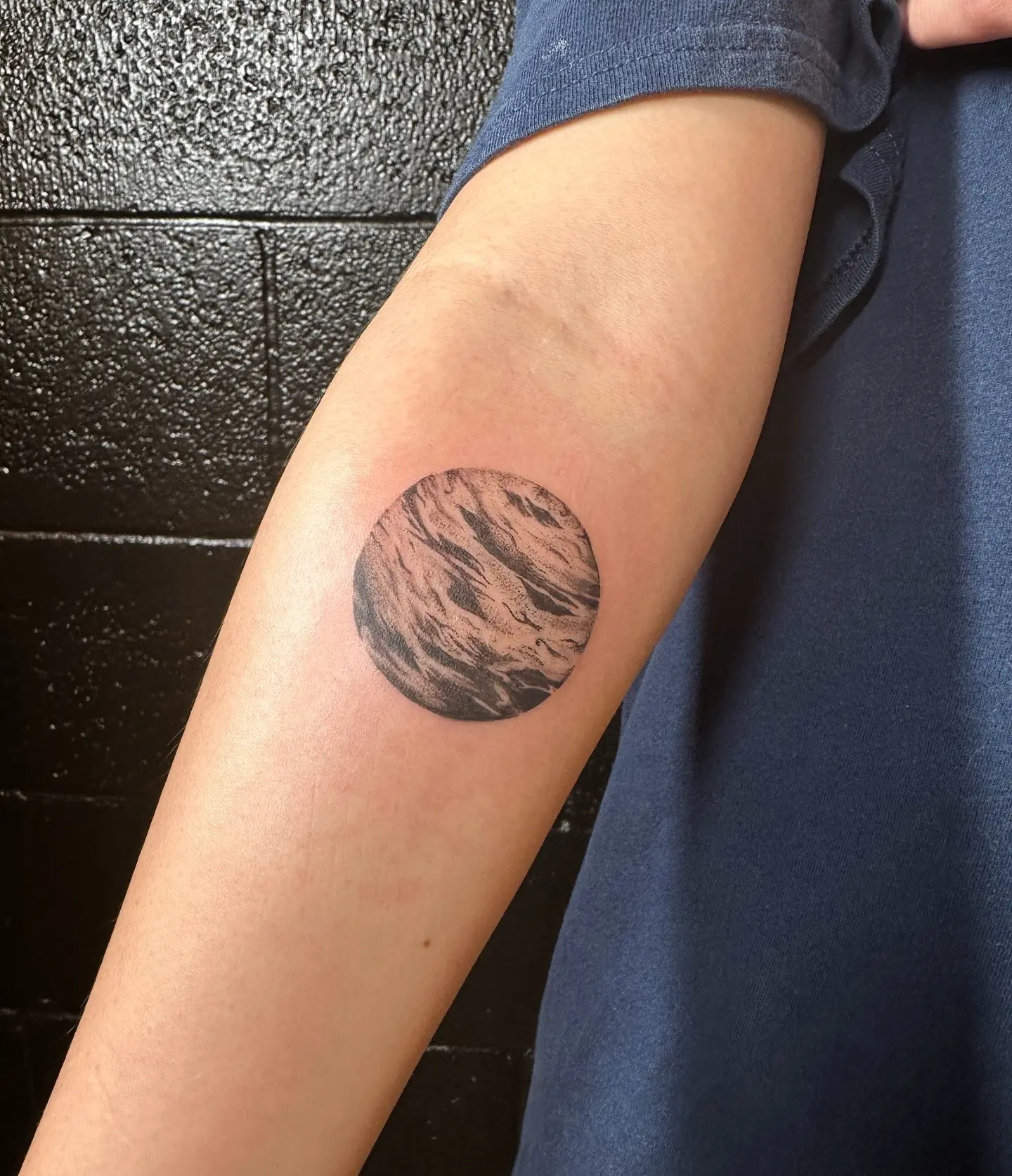 Stylized globe tattoo with textured details