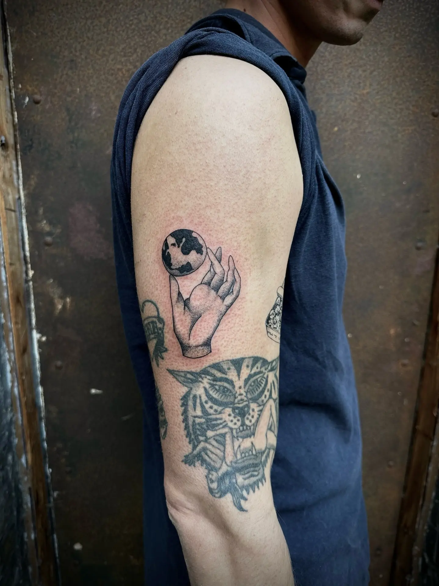 Artful globe tattoo capturing a delicate moment