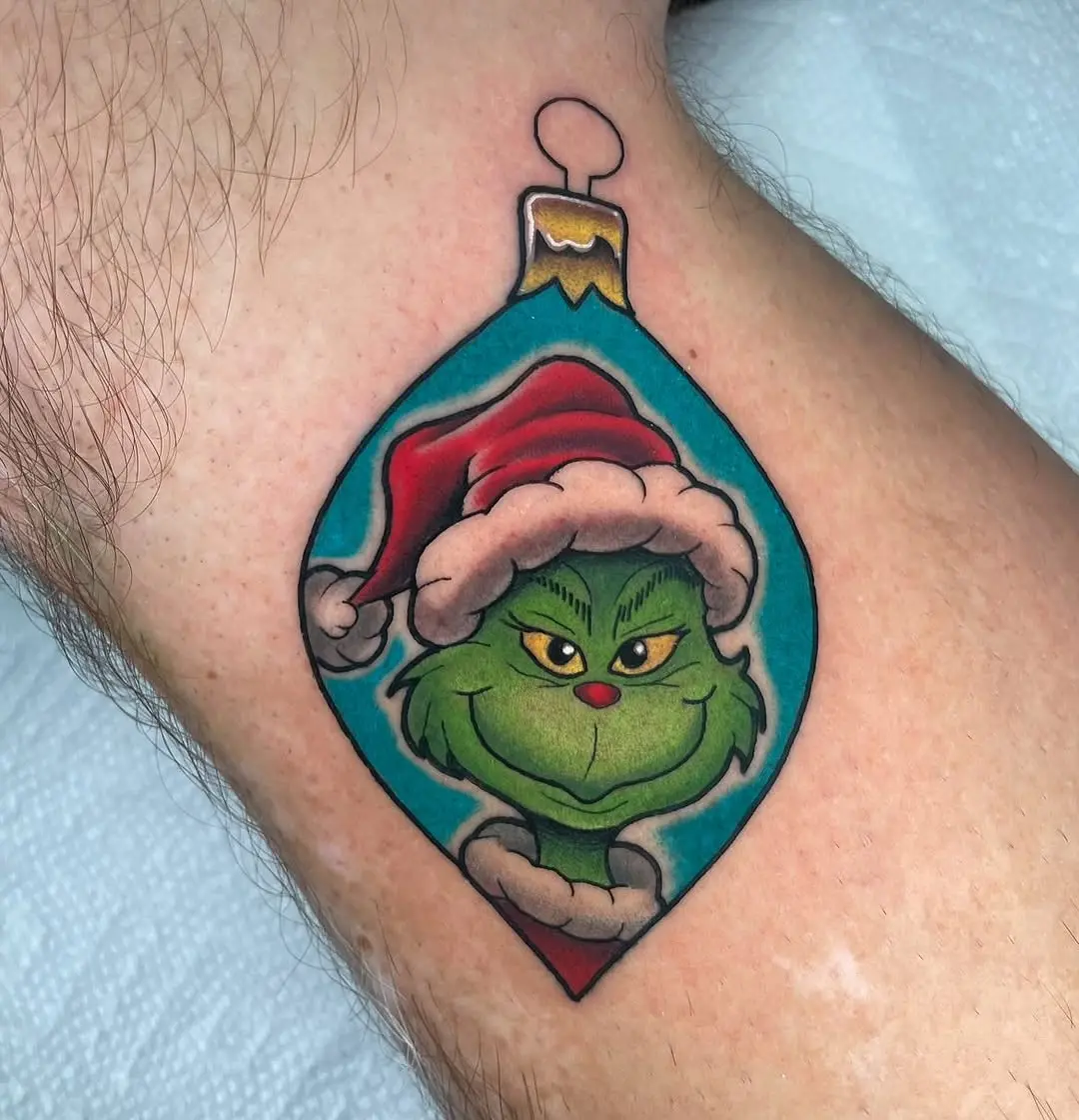 Whimsical Grinch in festive ornament tattoo design