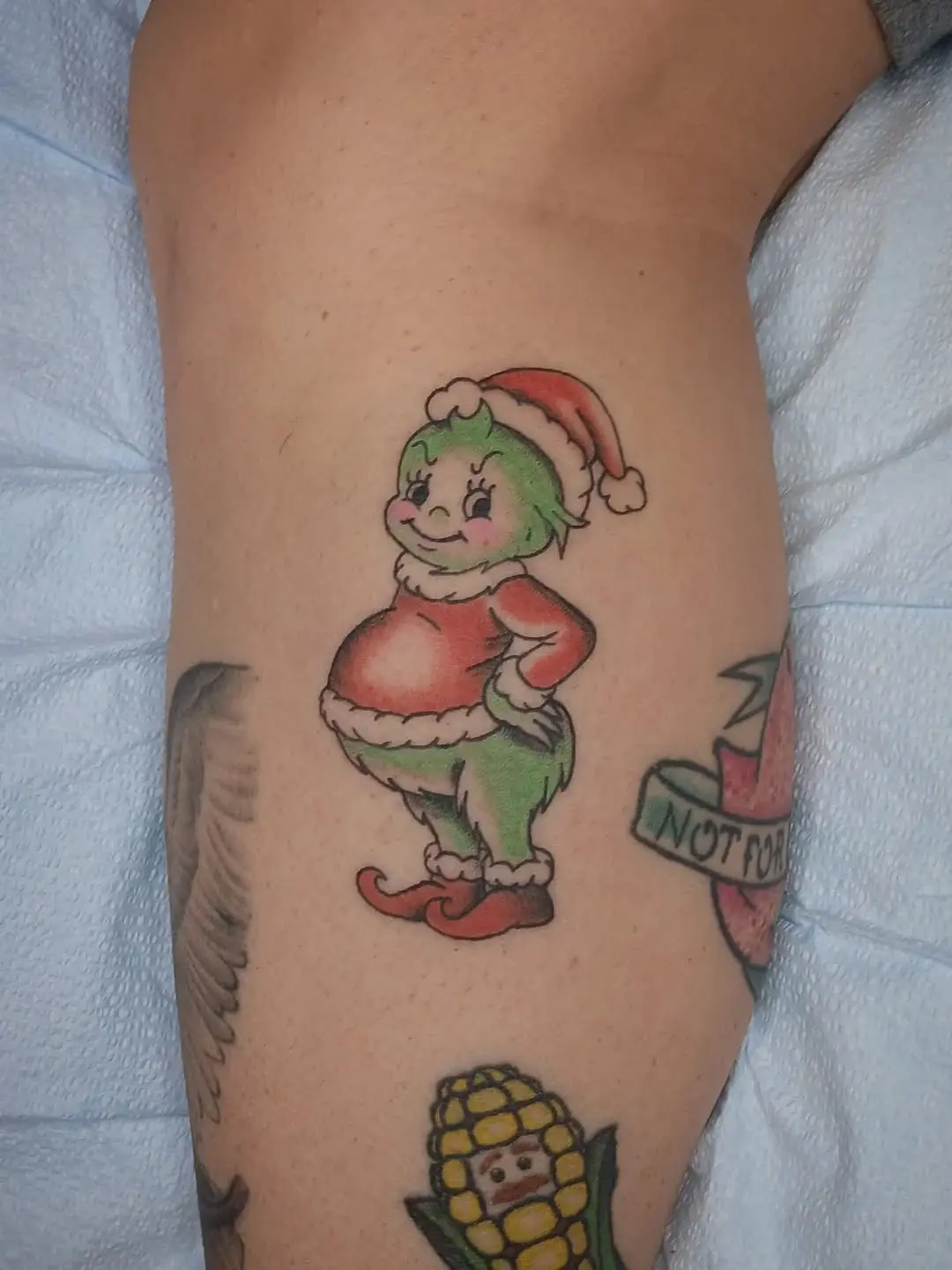 Whimsical Grinch Tattoo for Holiday Spirit