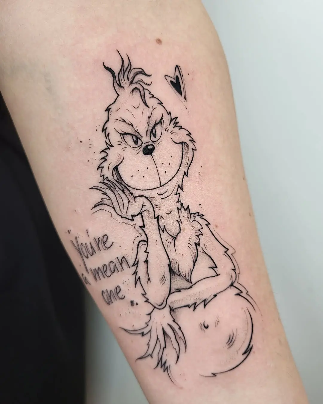 Playful Grinch Tattoo with a Cheeky Vibe