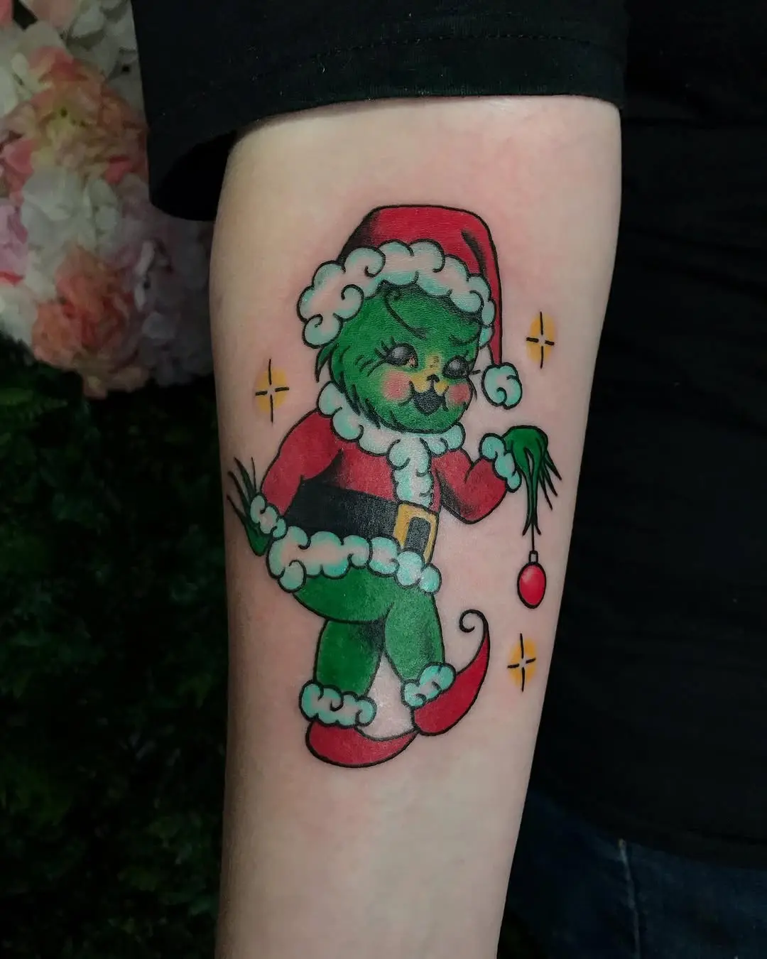 Playful Grinch in Santa Costume Tattoo