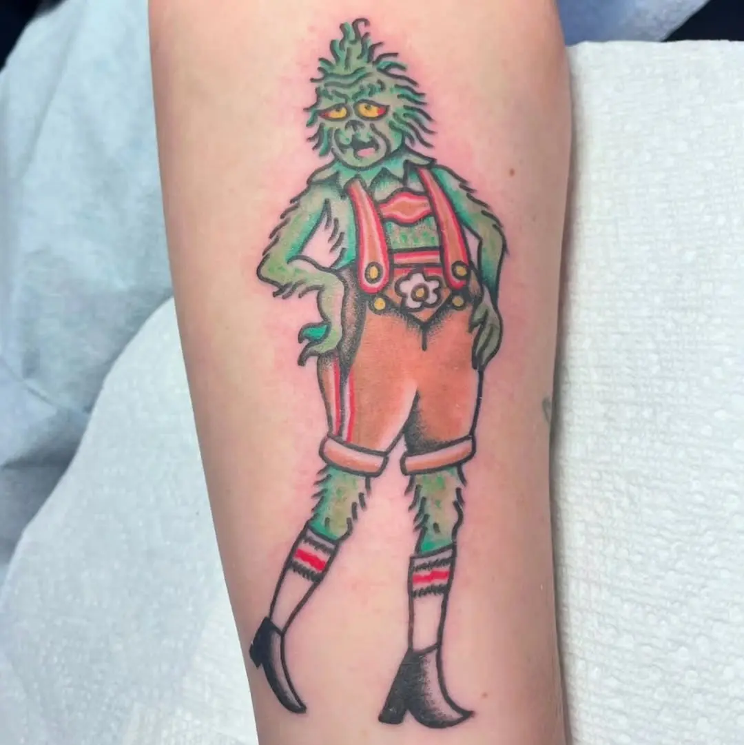 Stylized Grinch Tattoo with Fashionable Flair
