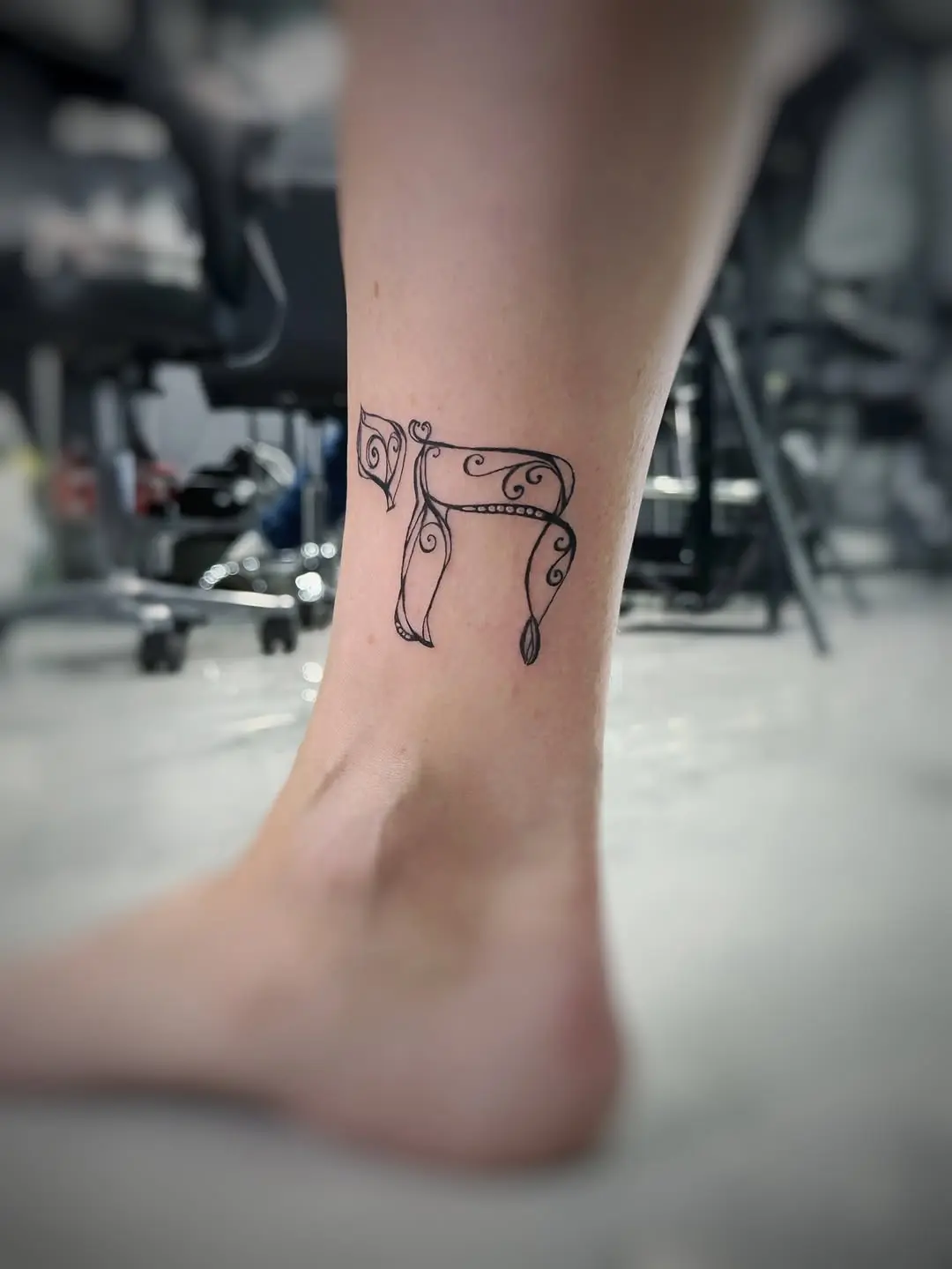 Elegant Hebrew Script Tattoo on Ankle