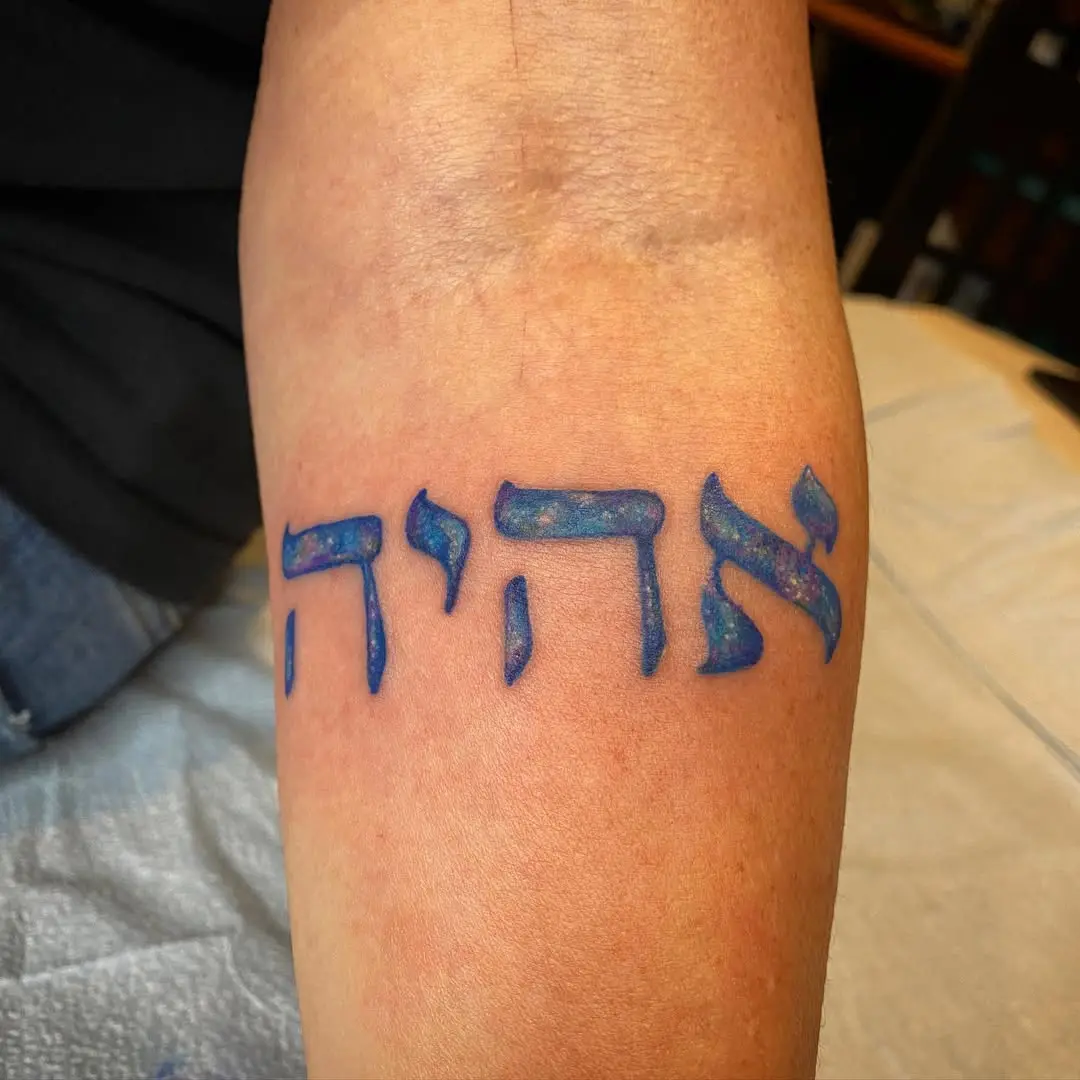 Vibrant Hebrew Tattoo with Cosmic Flair