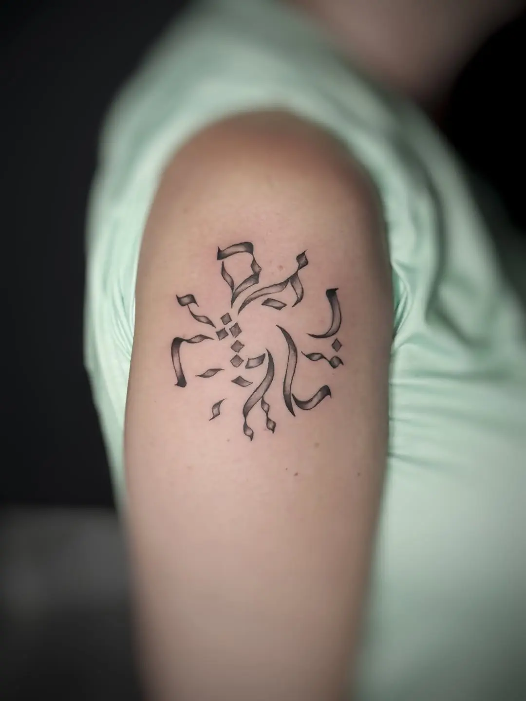Intricate Hebrew tattoo with flowing lines