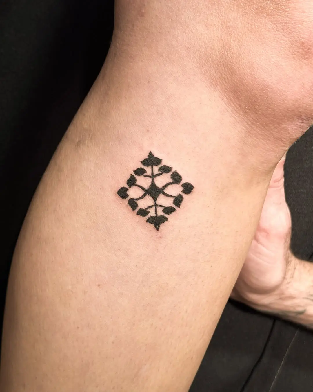 Elegant Hebrew tattoo with leaf motifs