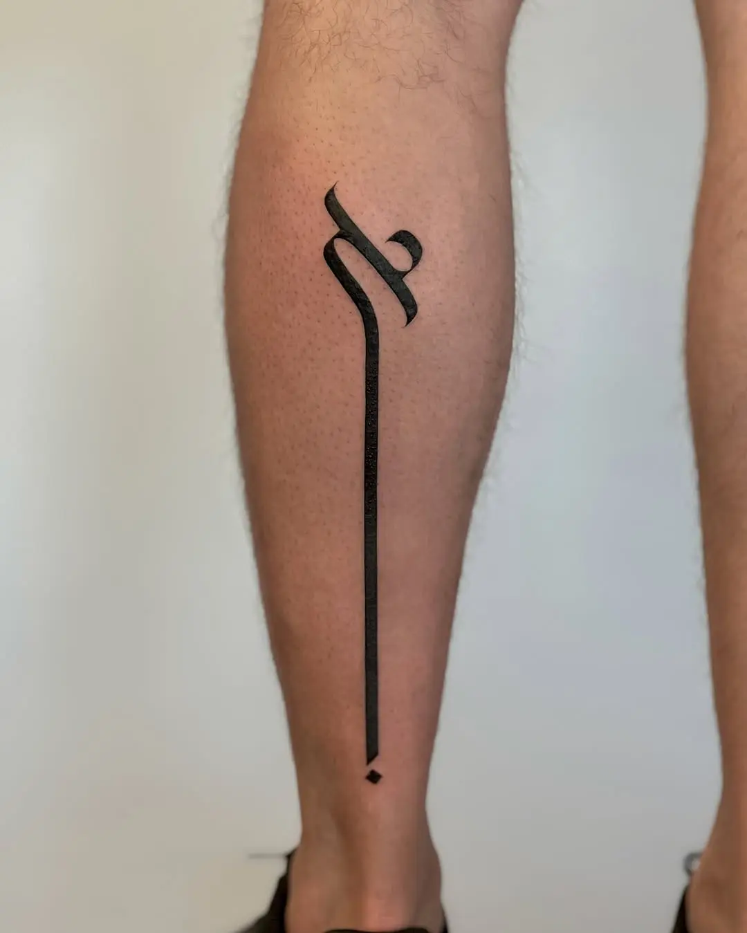 Minimalist Hebrew tattoo with sleek lines