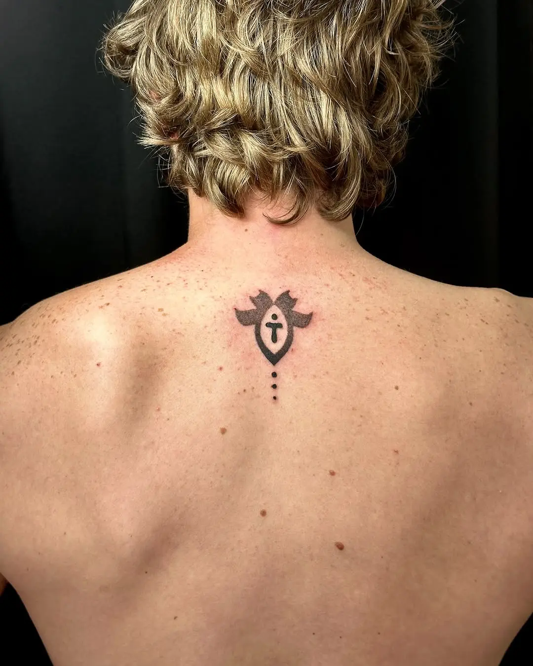 Minimalistic Hebrew tattoo with symbolic design