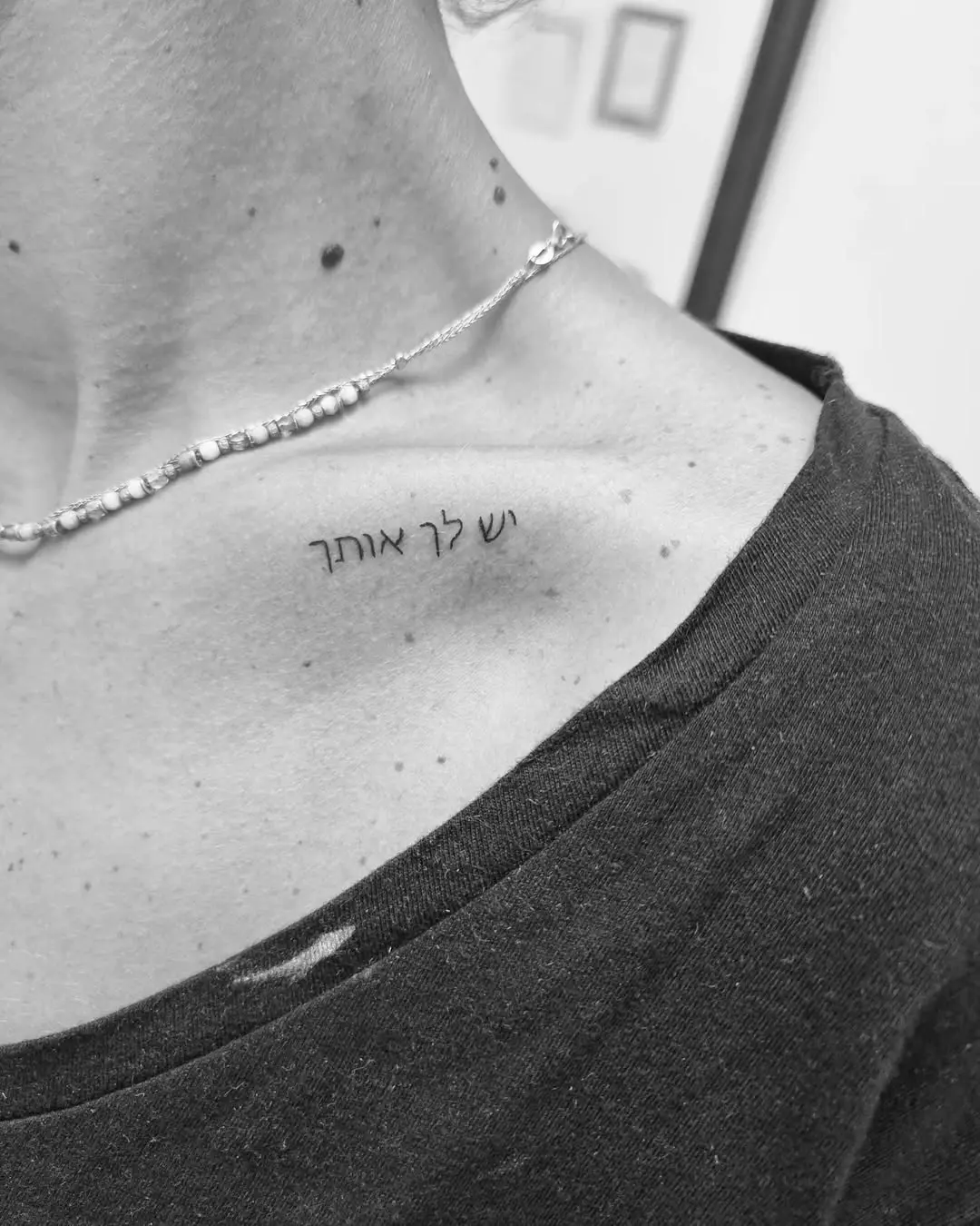 Elegant Hebrew Tattoo on the Collarbone