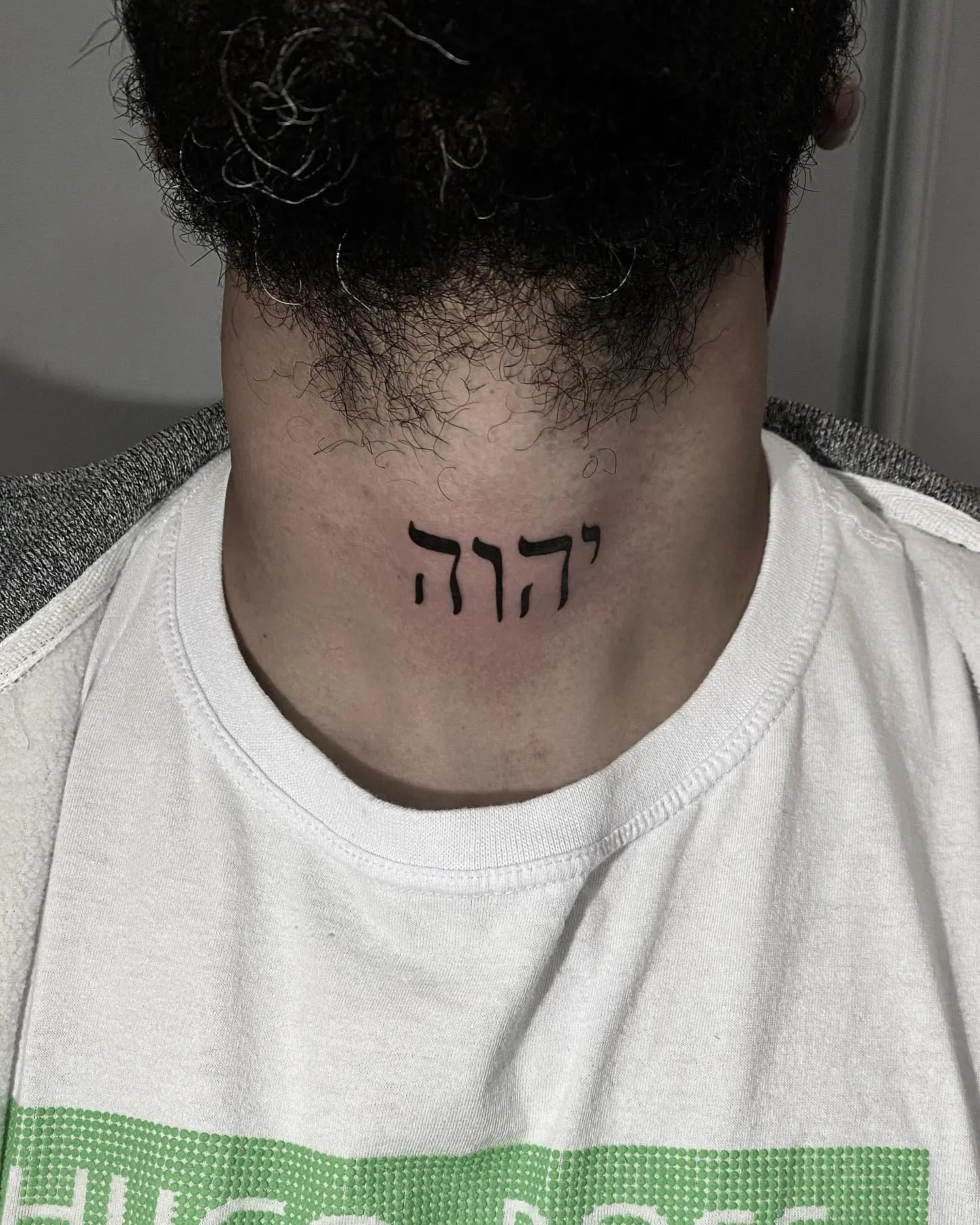 Bold Hebrew Scripture Tattoo on the Neck