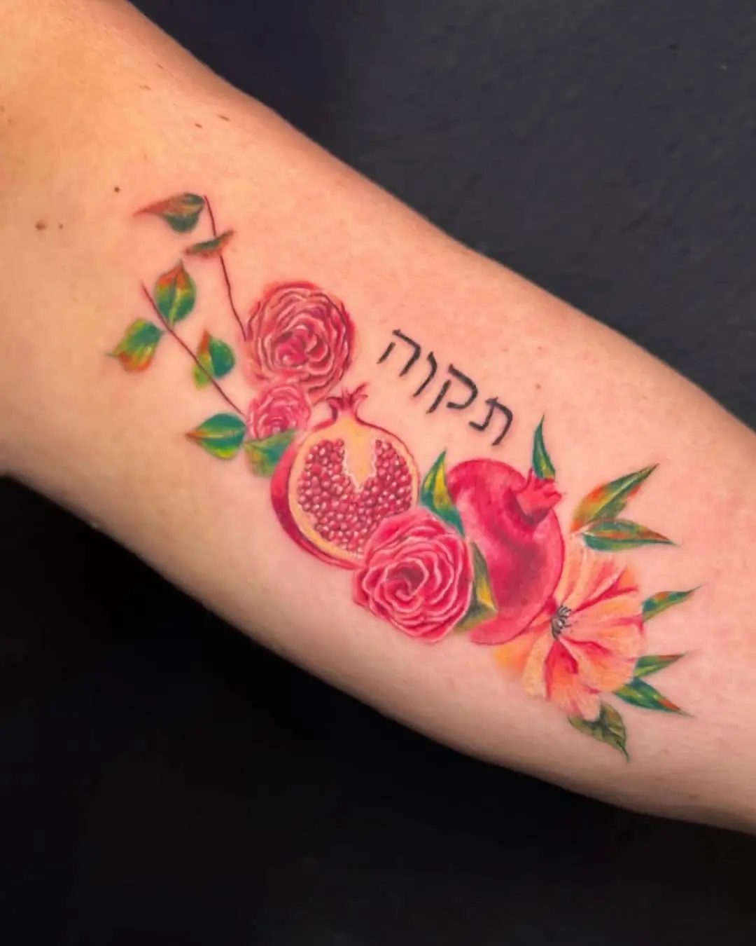 Vibrant Hebrew Tattoo Featuring Pomegranate