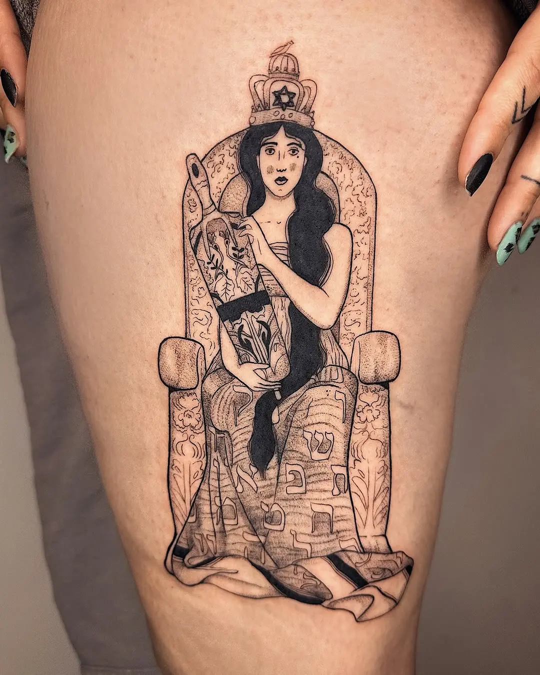 Intricate Hebrew tattoo of a regal figure