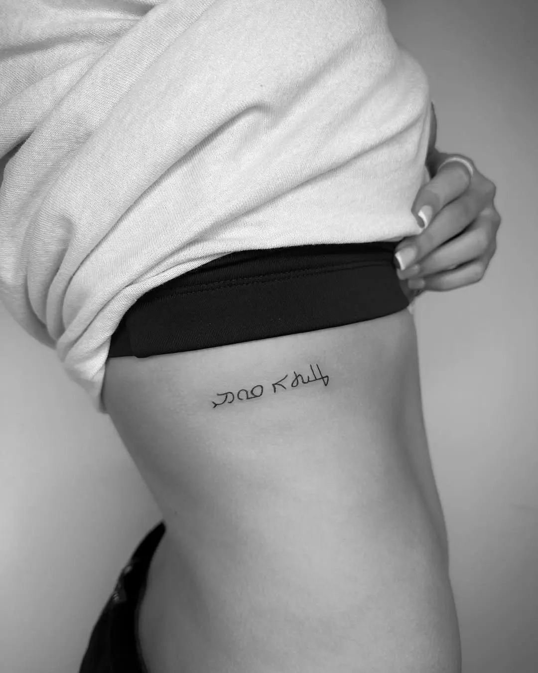 Elegant Hebrew Tattoo on Side of Body
